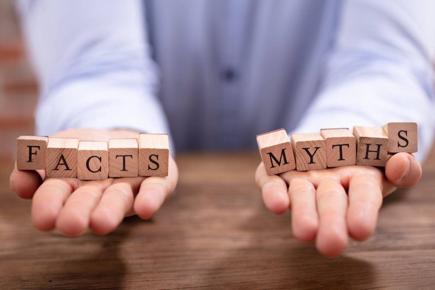 Hands holding block letters that read facts and myths