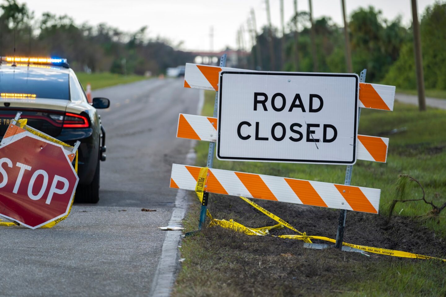 Police patrol car at warning roadworks sign