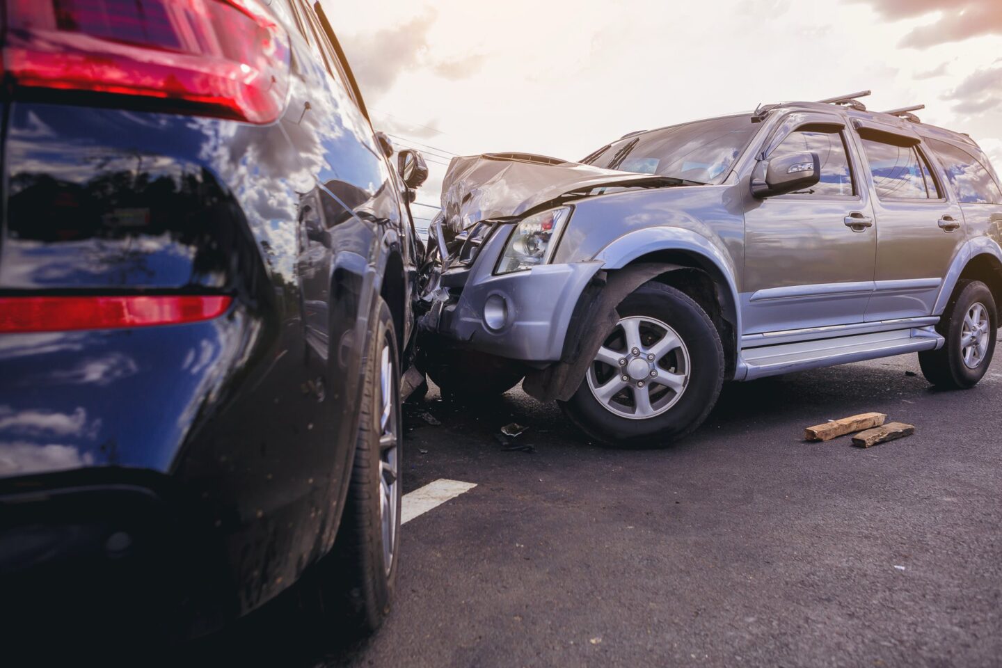 Silver car wrecked into a black car