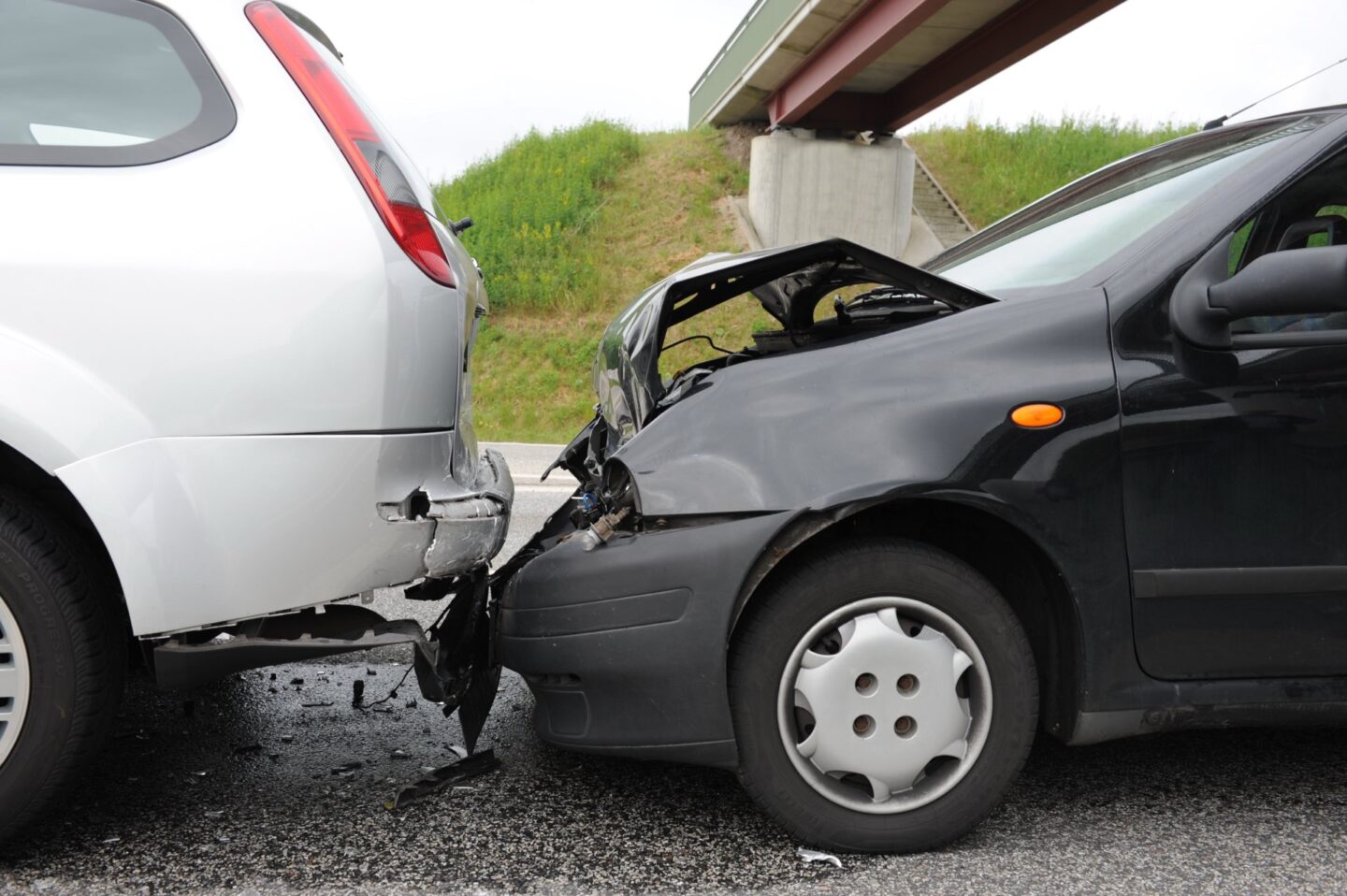 Black car involved in a rear end collision with a silver car