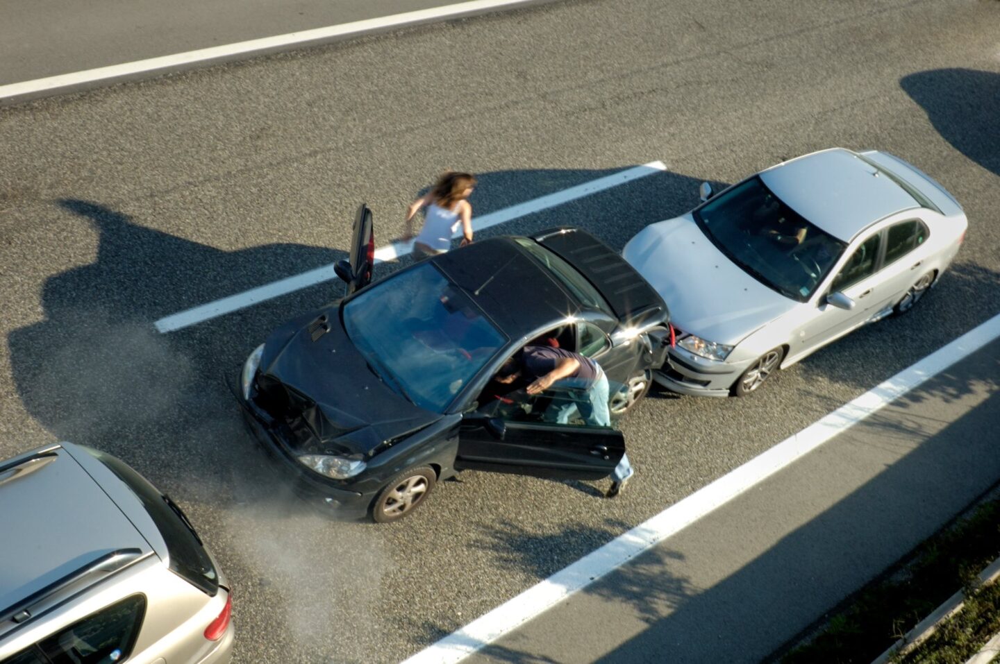 Fender bender with two people getting out of a black car