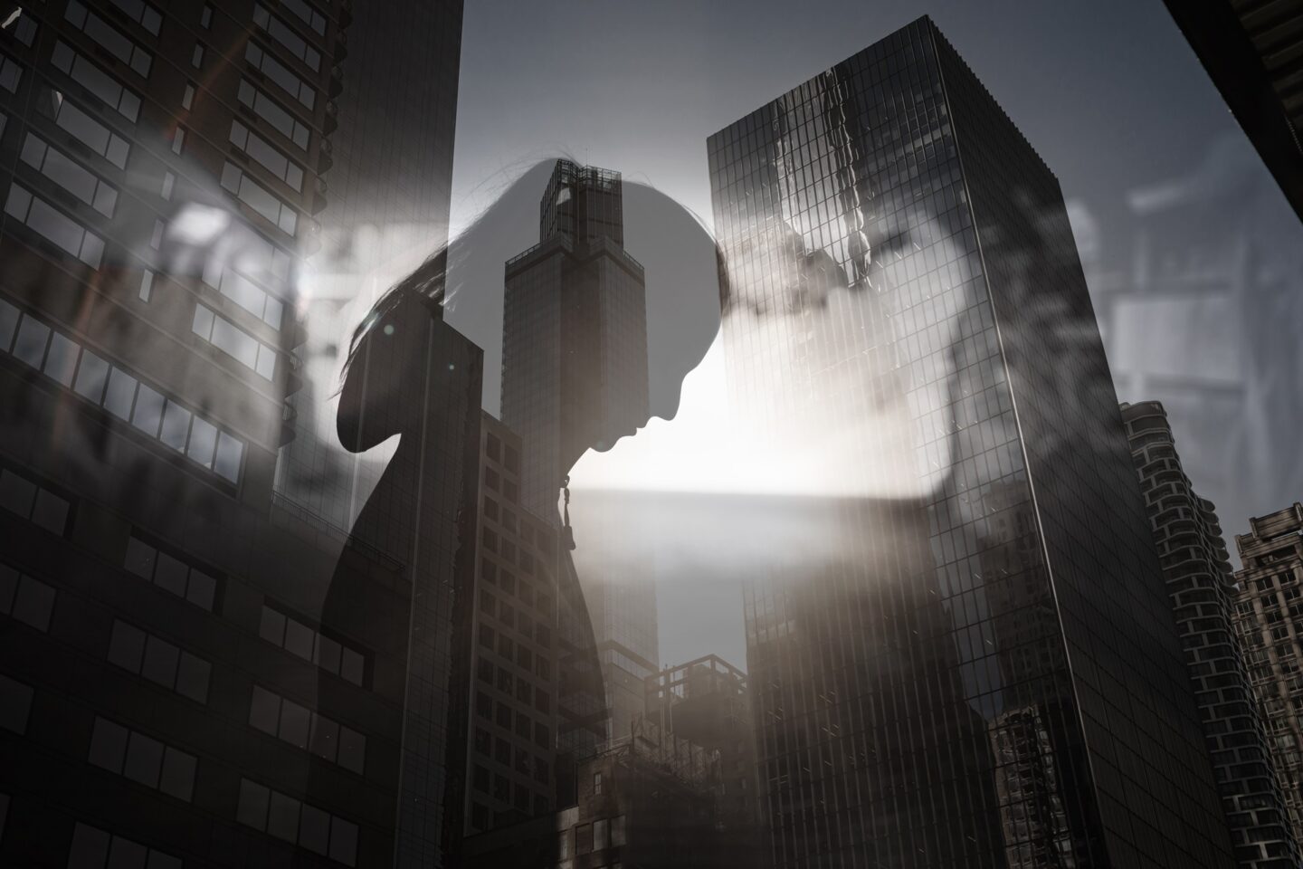 A silhouette of a woman laid against a city backdrop.